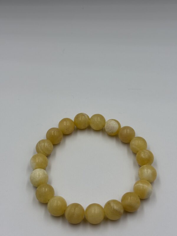 Carnelian agate stone bracelet with polished orange beads on an elastic cord